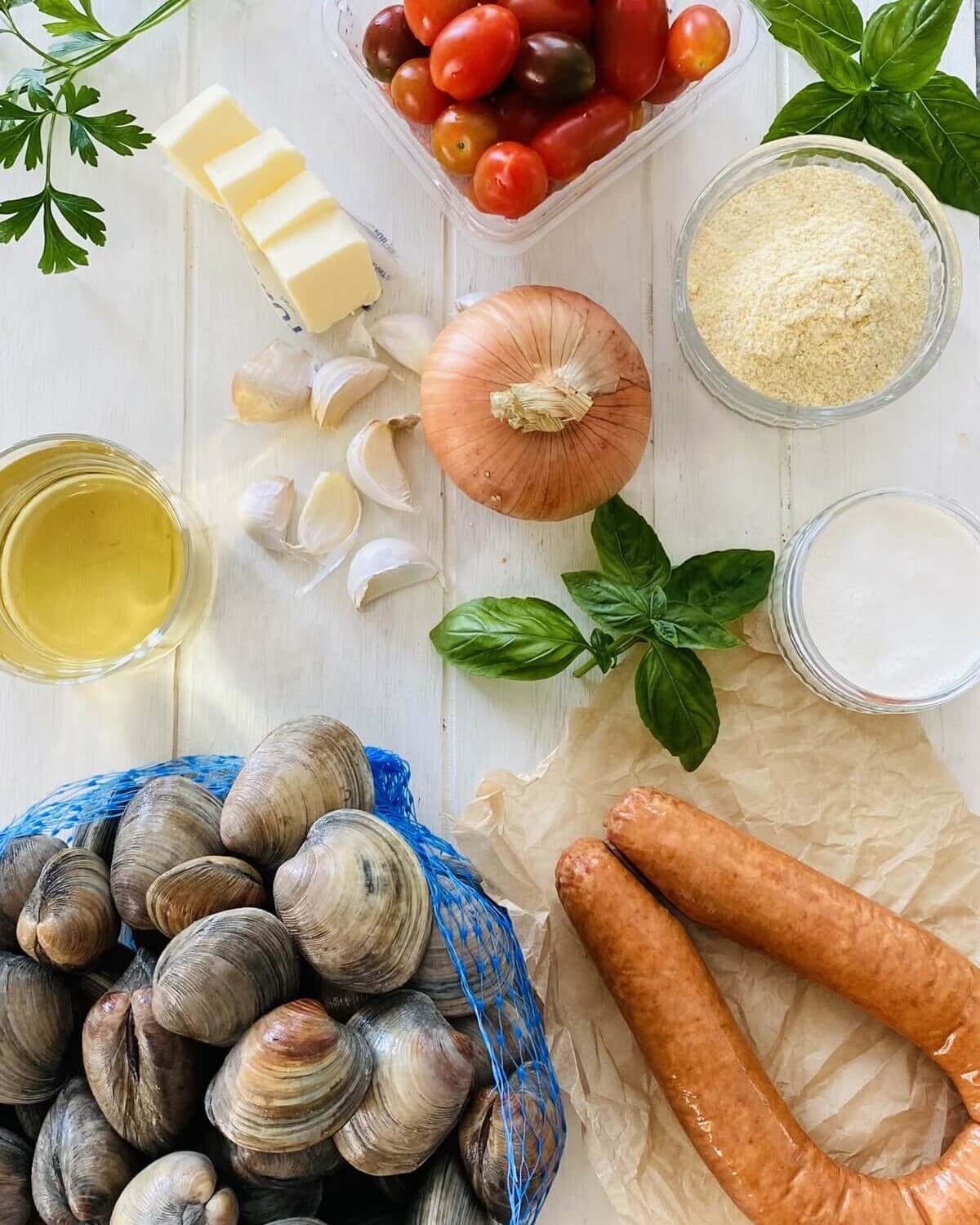 littleneck clams, kielbasa, white wine, onion, garlic, basil, cornmeal, butter.