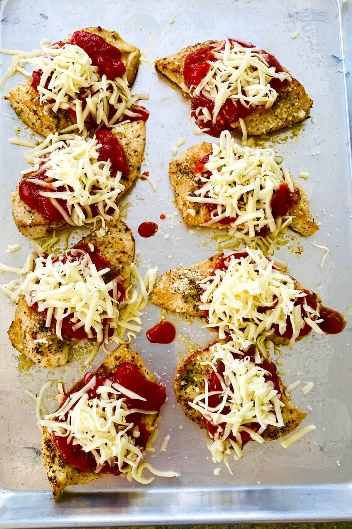 chicken parmesan topped with cheese and marinara.
