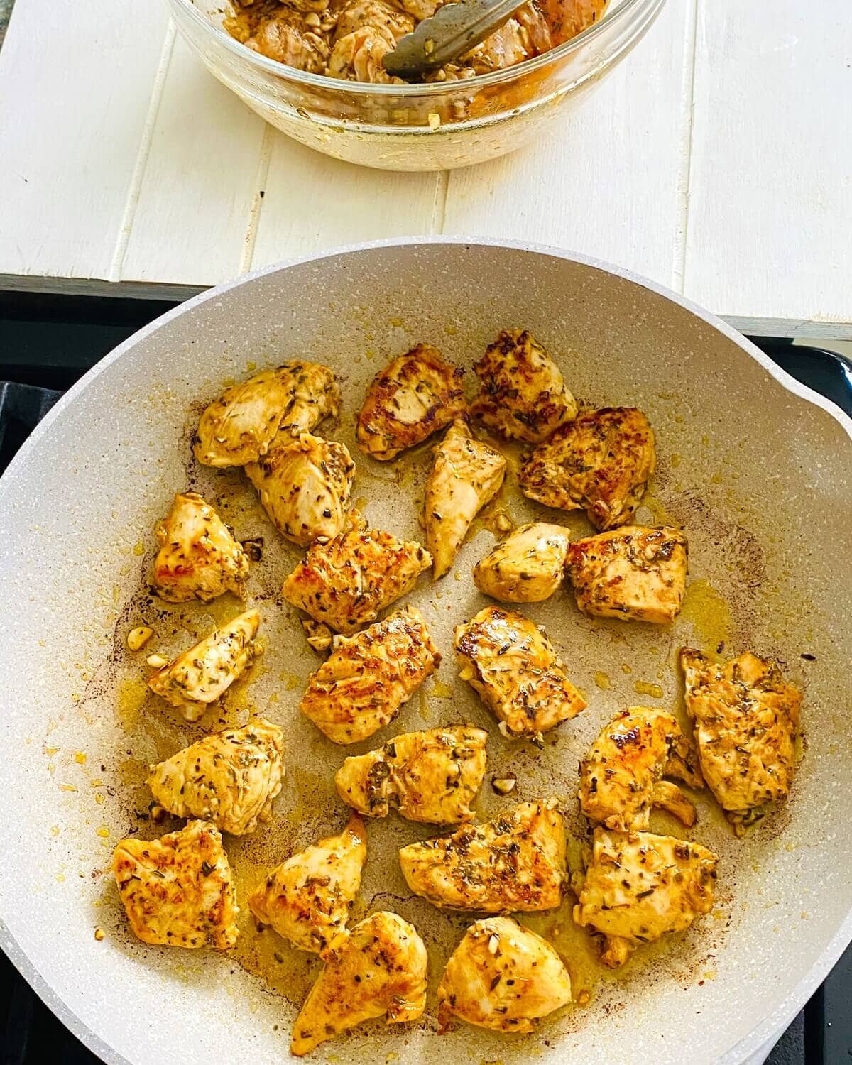 sautéing chicken in a pan.