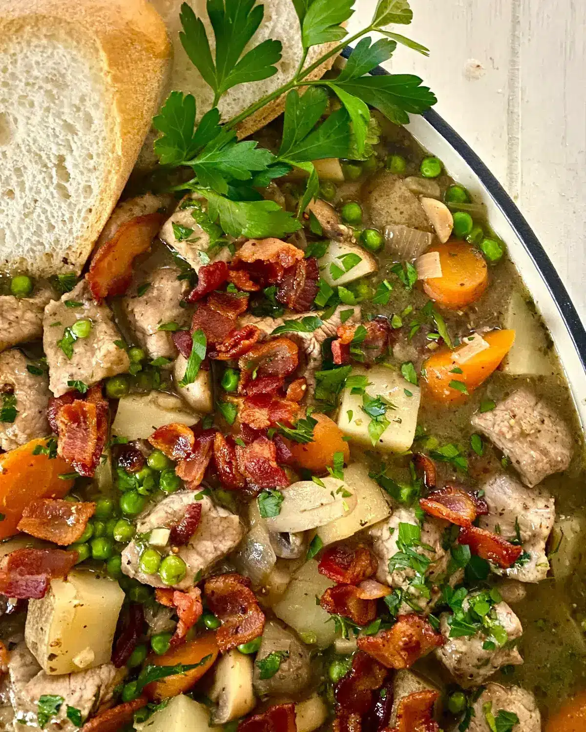 A dish with a pork tenderloin stew recipe with bread.