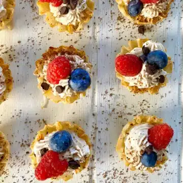 mini no bake cheesecakes with blueberries and raspberries.