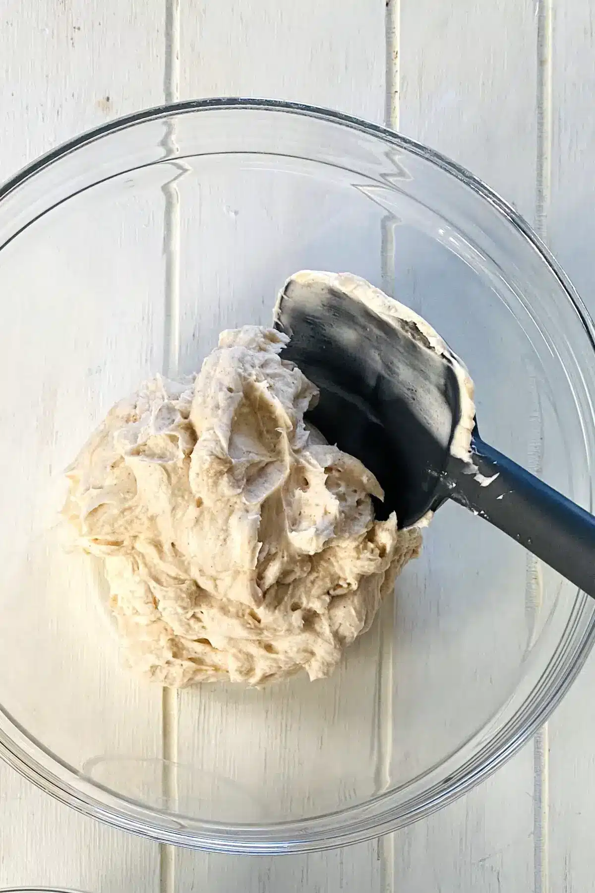 No bake cheesecake filling in a bowl with a spatula.