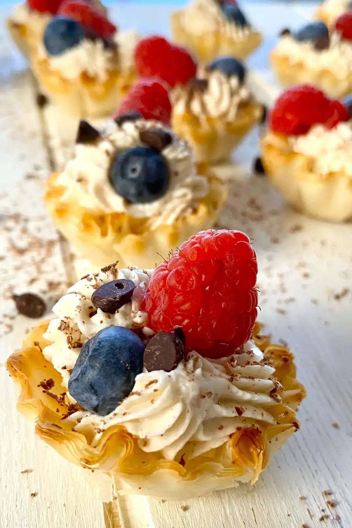 1 mini Philadelphia cheesecake topped with berries.