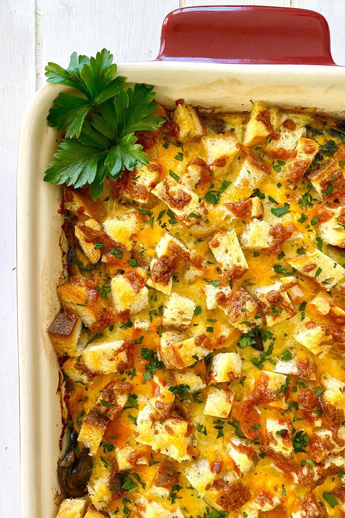 Breakfast Egg Casserole with Croutons, Sausage, Mushrooms and Spinach.