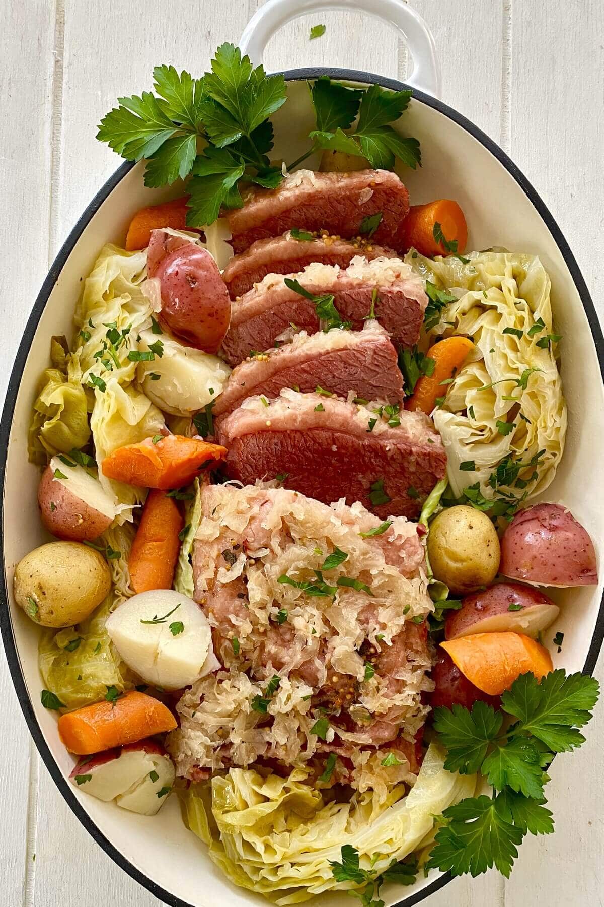 Instant Pot corned beef with cabbage, carrots and potatoes on a platter.