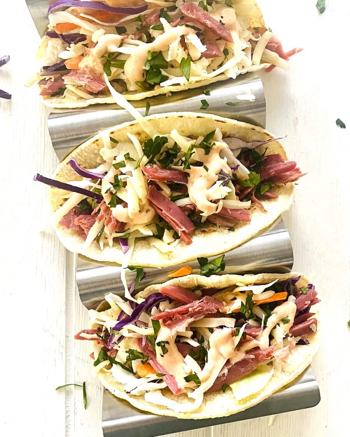 Irish tacos with corned beef in a taco holder.