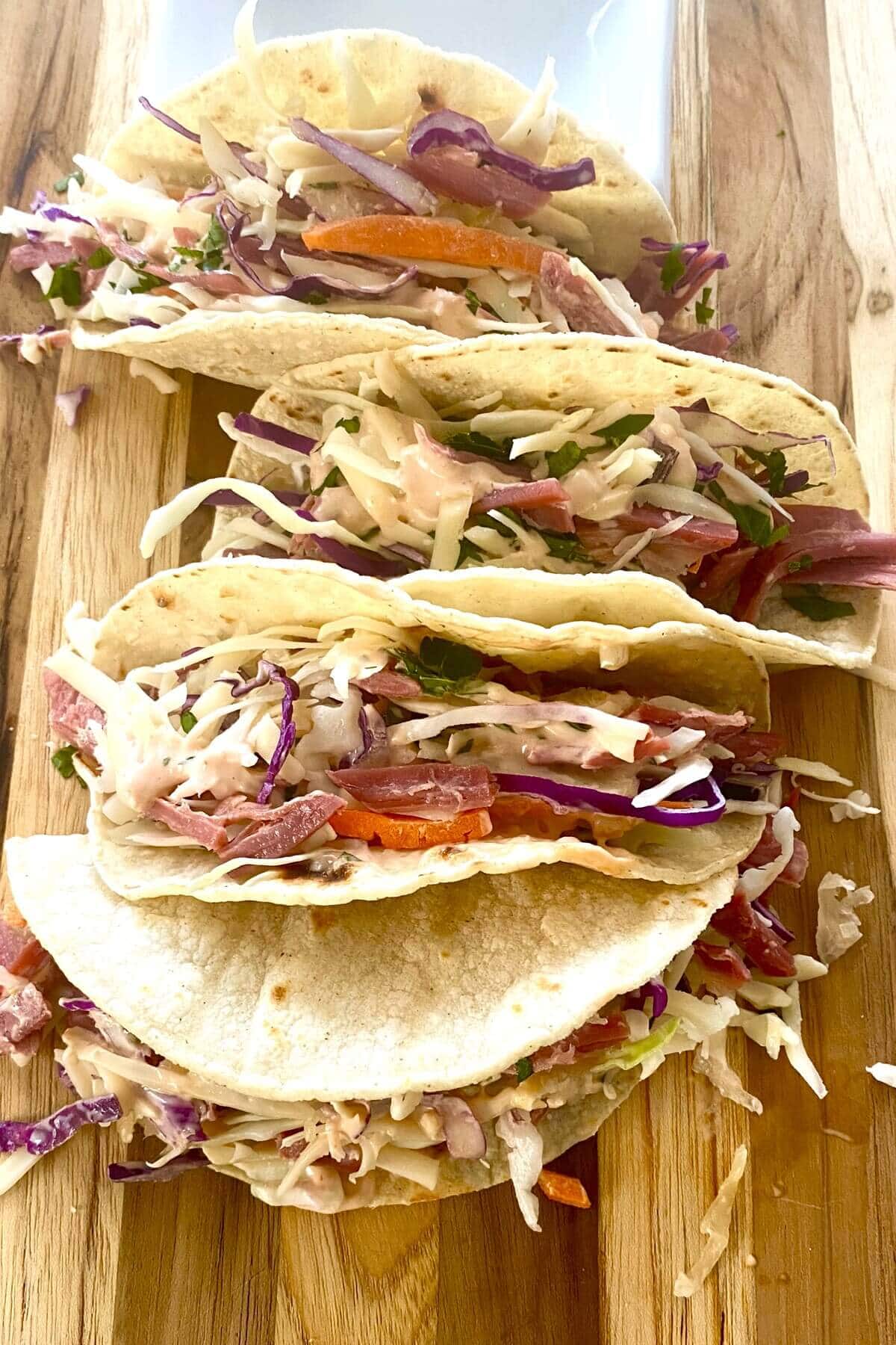 corned beef tacos on a cutting board.