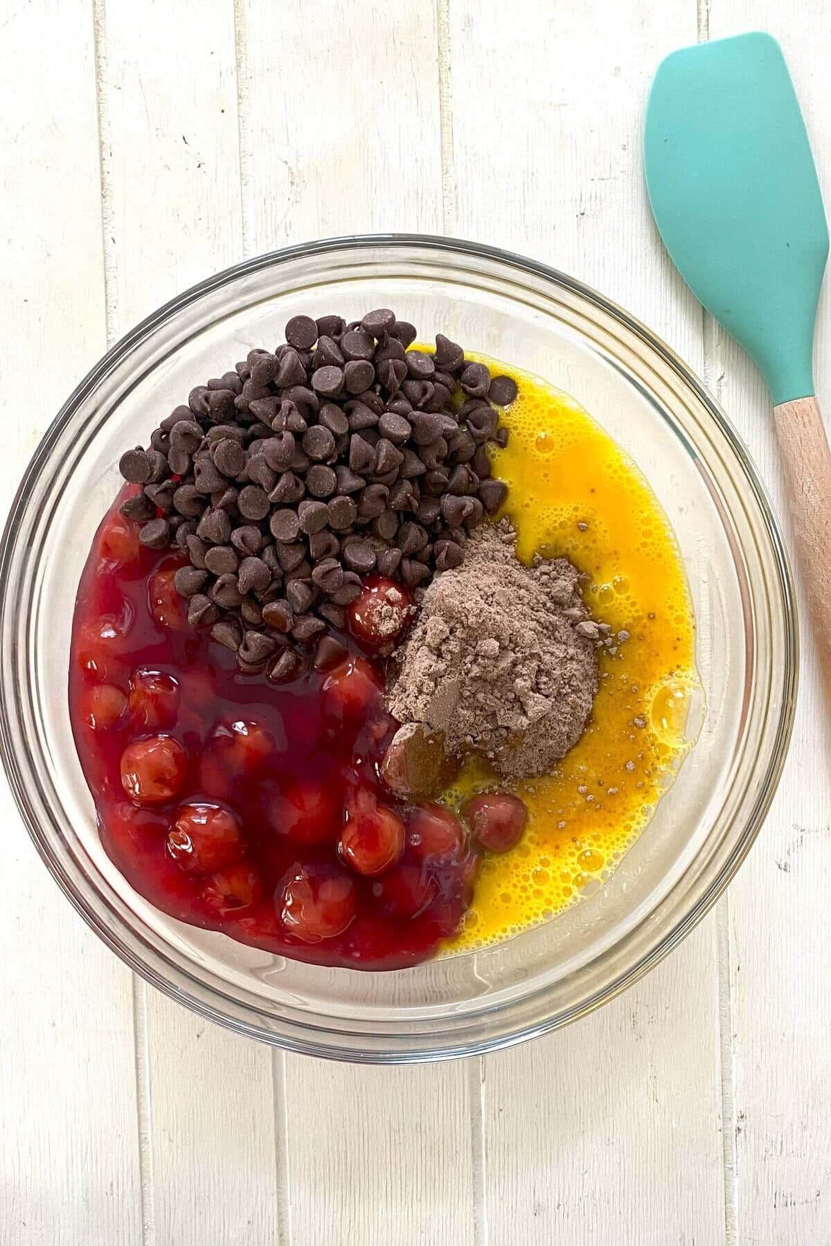 The cake ingredients of cake mix, cherry pie filling, eggs, chocolate chips.