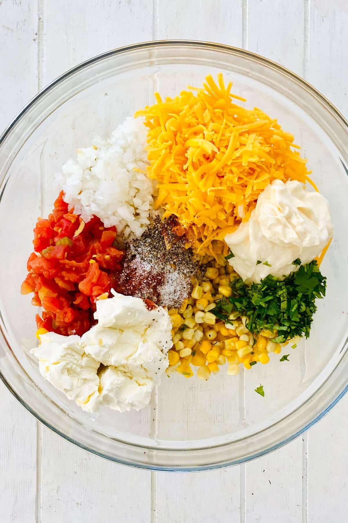corn, onion, cilantro, mayo in a bowl.