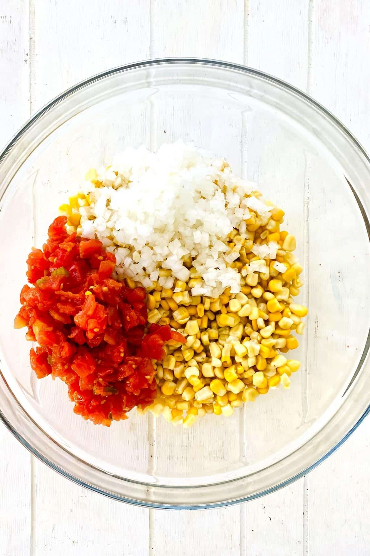 corn, onion, rotel tomatoes in a bowl.