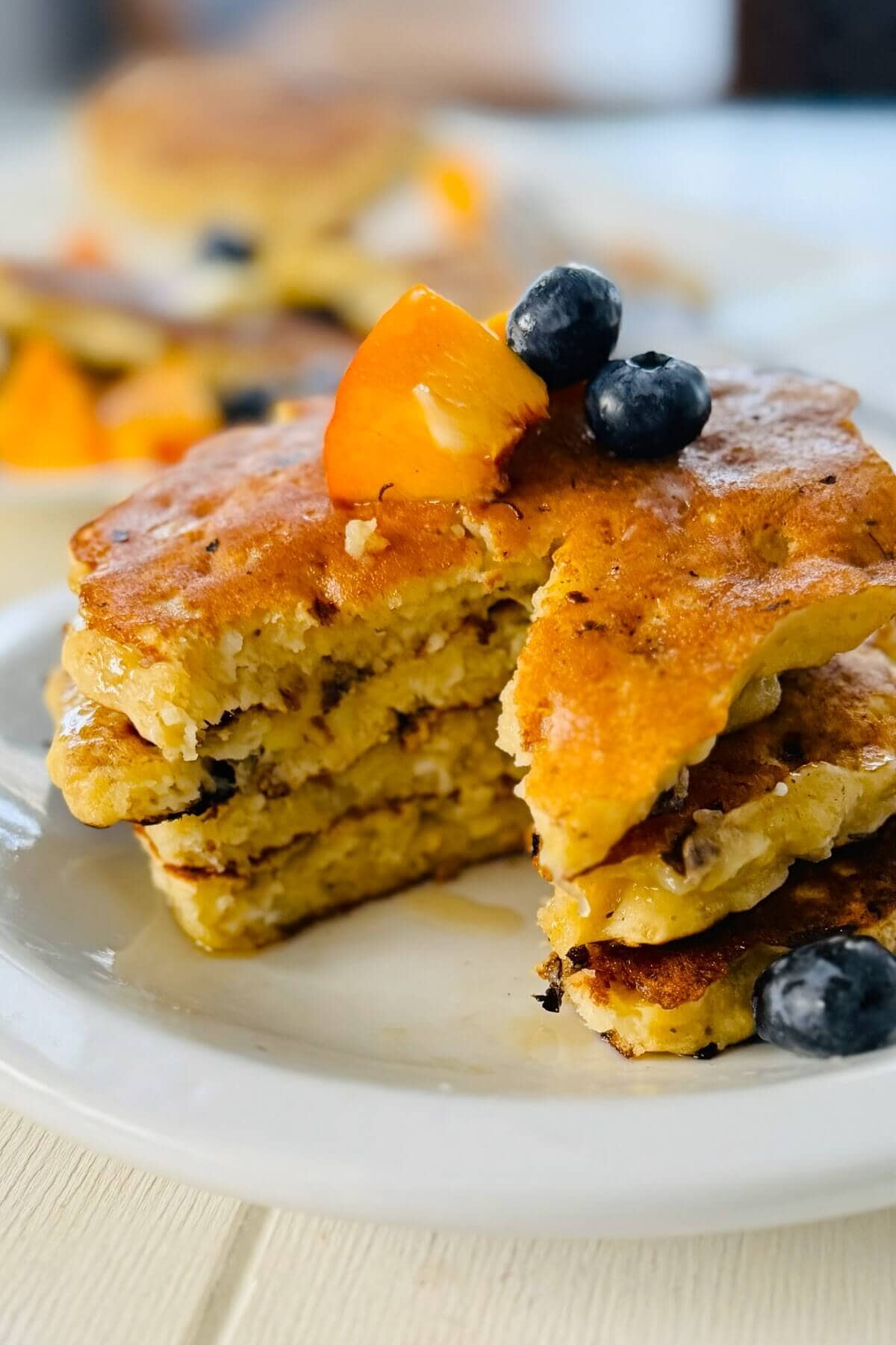 Stack of pancakes with bite cut out.