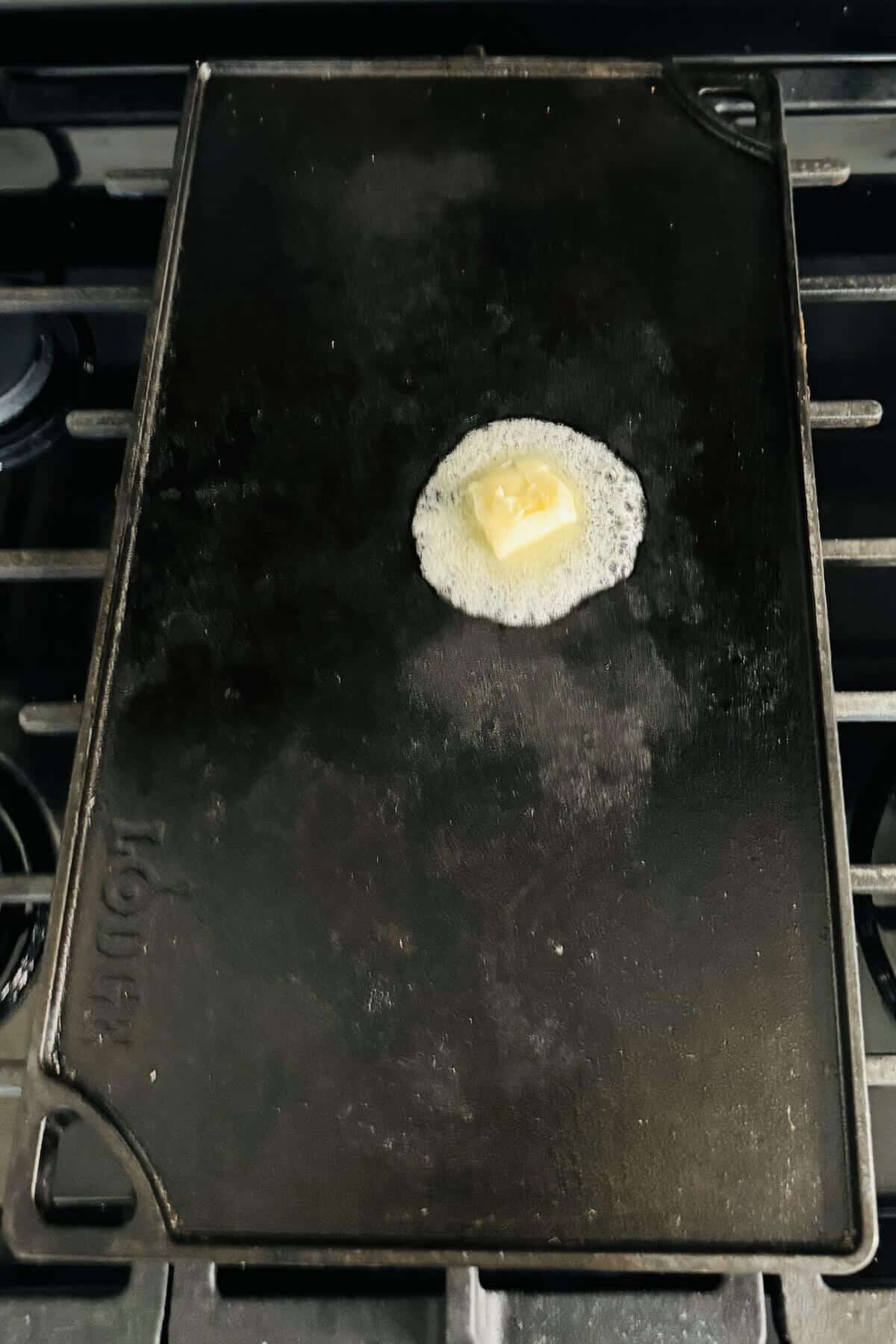 Melting butter on a griddle.