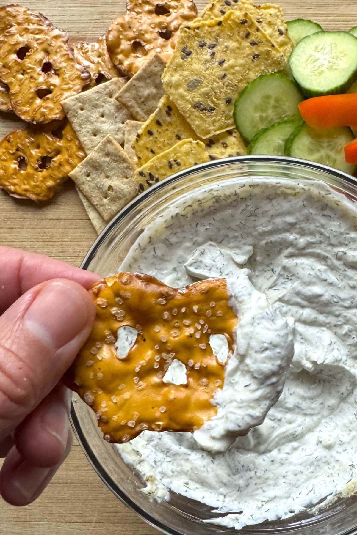 A pretzel thin with dip on it.