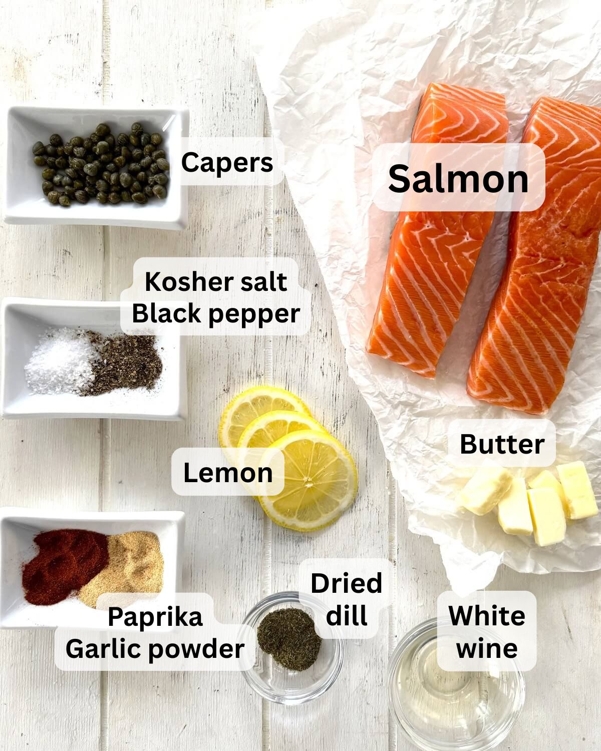 Salmon, butter, capers, wine, lemon slices, and spices.