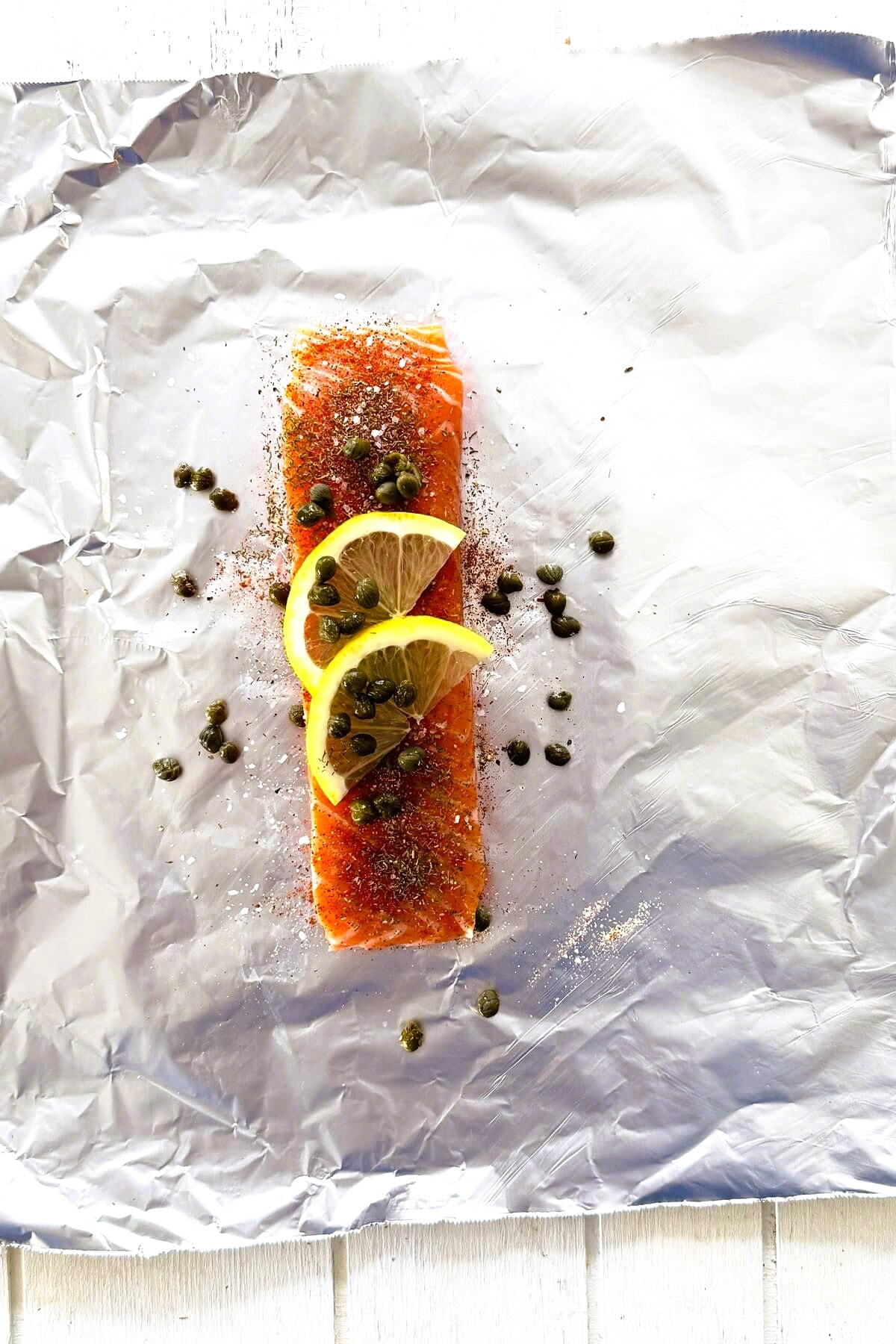 Salmon topped with spices, lemon and butter.
