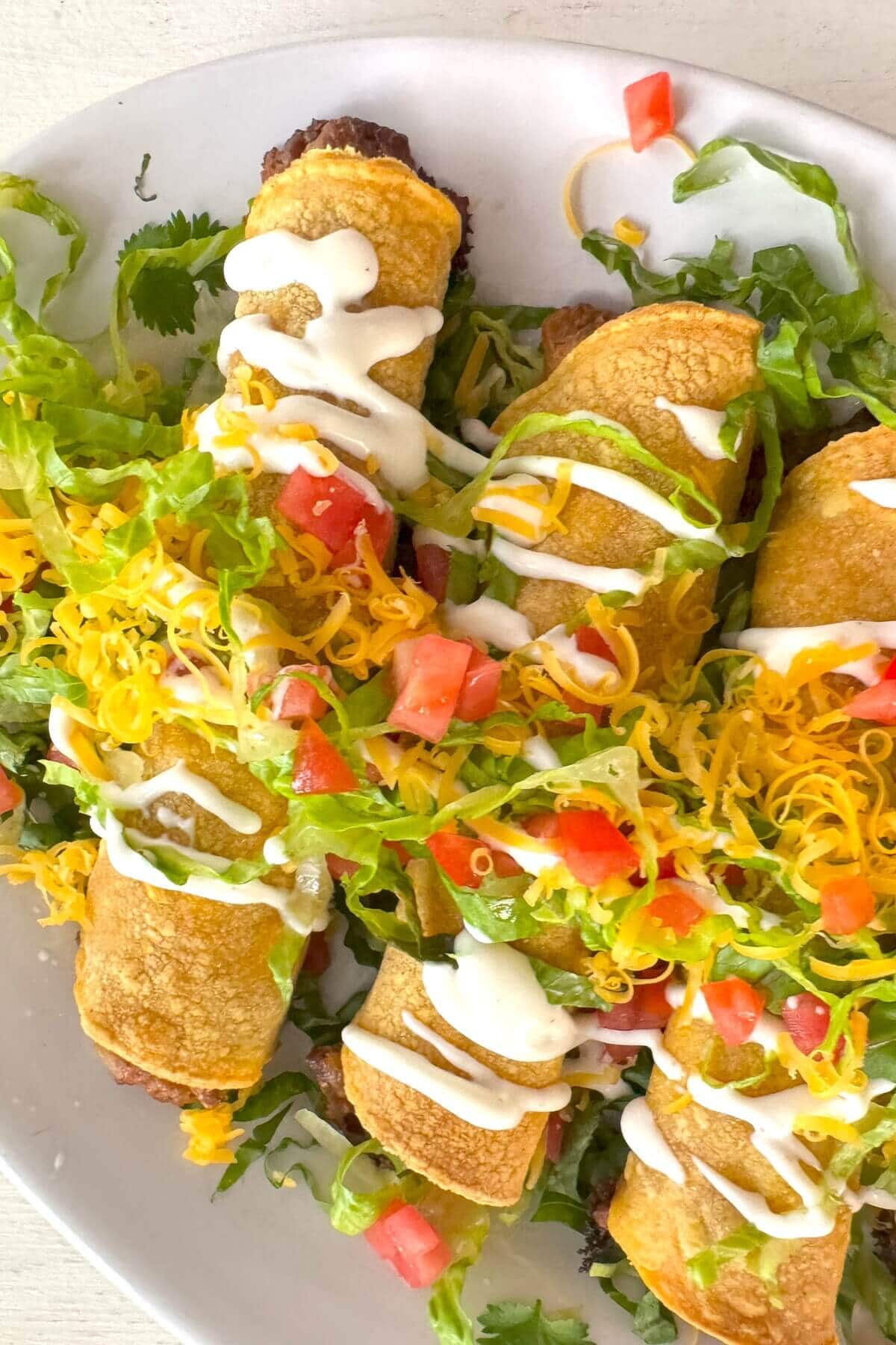 A plate of rolled tacos.