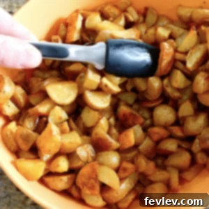 Perfectly crispy oven baked breakfast potatoes, golden brown and seasoned to perfection, served on a plate.