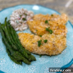 Golden-brown, perfectly crispy baked chicken tenders on a cooling rack, ready to be served, suggesting a delicious and healthy meal option.