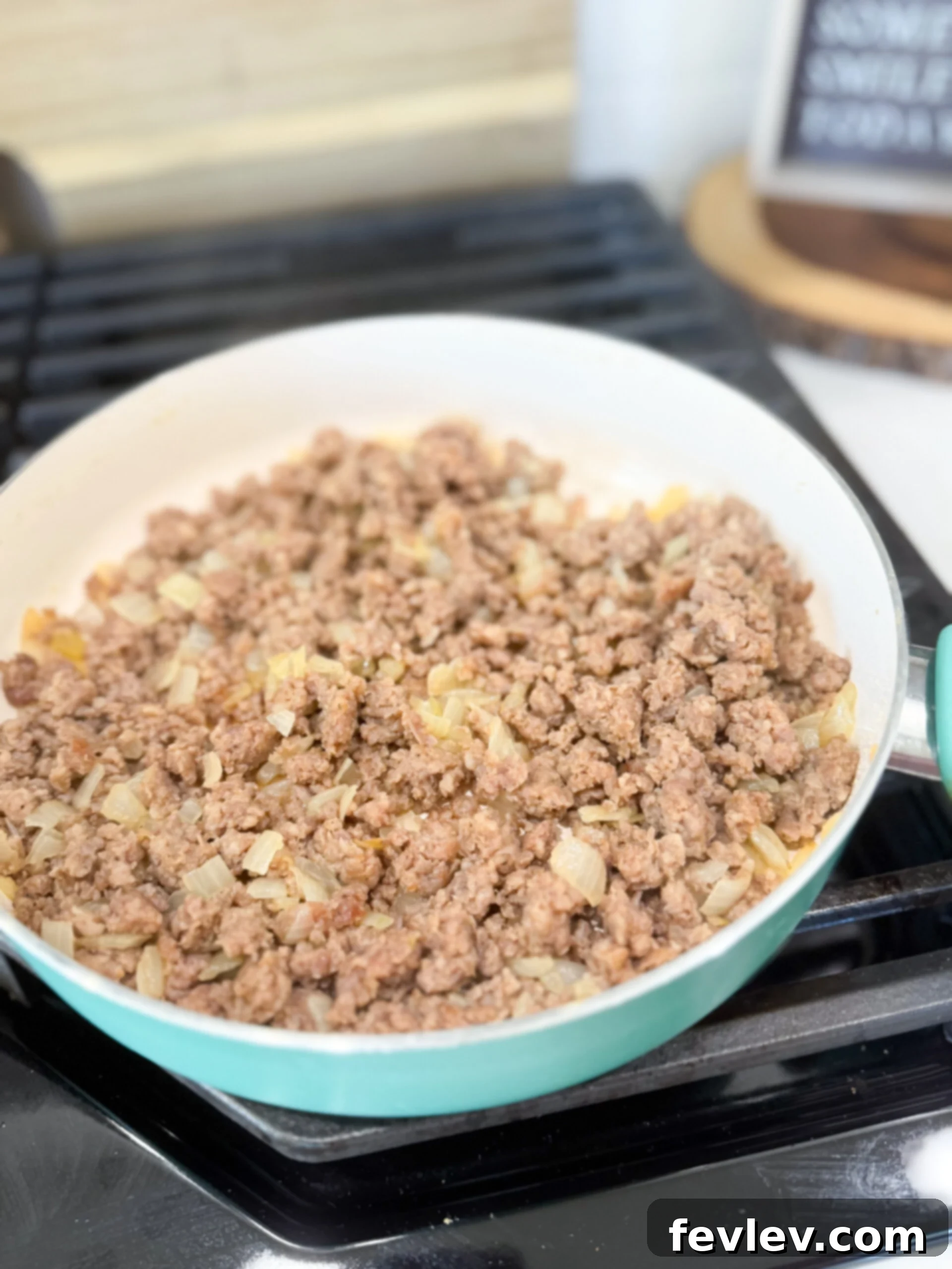 Easy Slow Cooker Zuppa Toscana 5 Cooking Italian sausage and diced white onion in a skillet over medium heat until browned and fragrant.