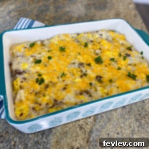 A delicious and comforting Grits Breakfast Sausage Casserole, baked to golden perfection with melty cheese on top, ready to serve.