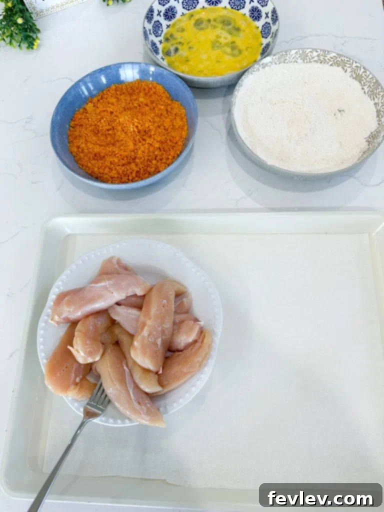 Bold Doritos Crispy Tenders 5 Breading station set up with flour, egg, and crushed Doritos