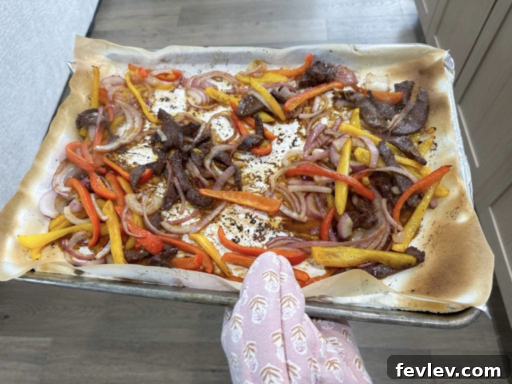 Oven-Baked Steak Fajita Feast 4 easy sheet pan steak fajitas cooking on sheet pan