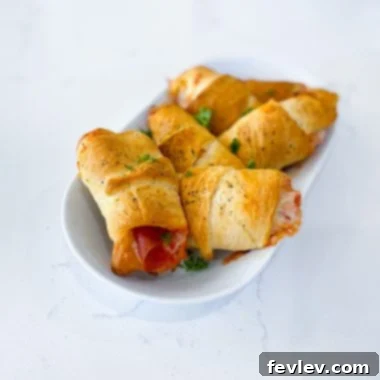 Golden baked pizza crescent pockets filled with cheese and pepperoni, ready to be enjoyed.