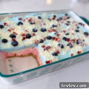 Delicious Double Berry No-Bake Lasagna, a perfect chilled summer dessert with layers of creamy filling, fresh strawberries, blueberries, and golden Oreo crust.