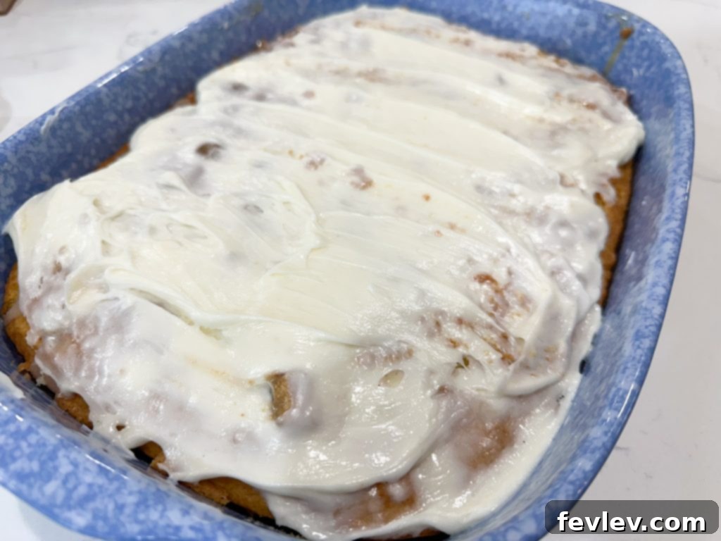 Glazed Cinnamon Roll Indulgence 2 Delicious Cinnamon Roll Poke Cake with homemade frosting