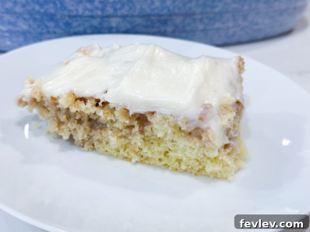 Glazed Cinnamon Roll Indulgence 3 The best cinnamon roll poke cake ready to be served