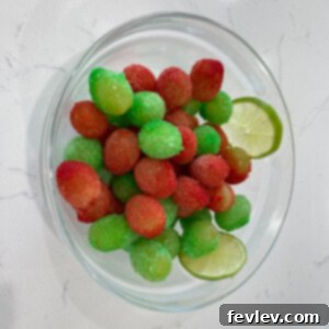 Delicious Sour Patch Grapes coated in colorful jello powder, ready to be enjoyed as a refreshing snack.