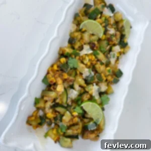 Close-up of a delicious Parmesan Zucchini Skillet, showing caramelized zucchini and corn with fresh cilantro and Parmesan cheese.