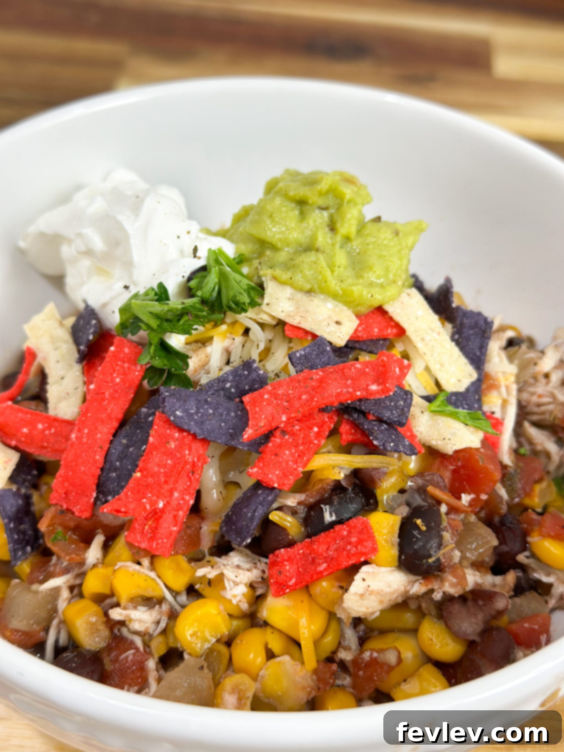 One-Pot Chicken Burrito Bowls 2 A vibrant, easy slow cooker chicken burrito bowl garnished with fresh avocado, cilantro, and a squeeze of lime.