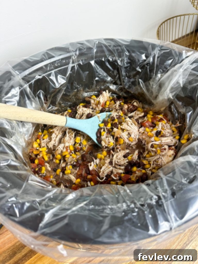 One-Pot Chicken Burrito Bowls 5 A finished slow cooker chicken burrito bowl with shredded chicken, beans, and corn, ready to be served.