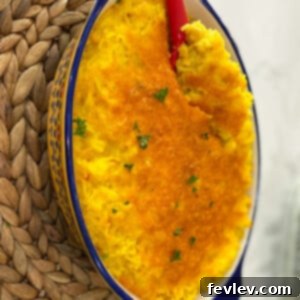 Delicious Alison's Yellow Rice Casserole with melted cheese, ready to serve