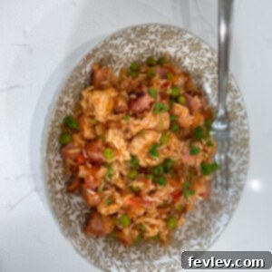 A deliciously creamy Ham, Chicken, and Rice Casserole, garnished and ready to serve.