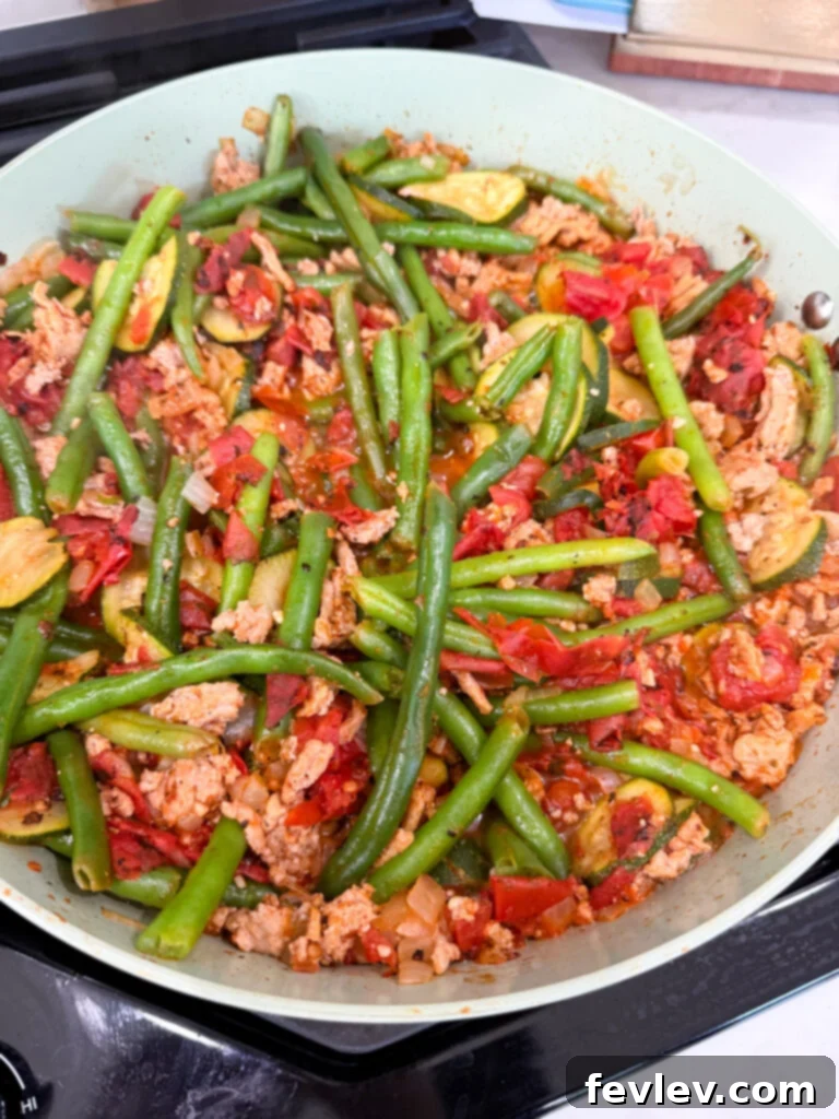 Wholesome Low-Carb Turkey and Veggie Skillet 8 Adding fire-roasted diced tomatoes and chicken broth to the turkey and vegetable skillet