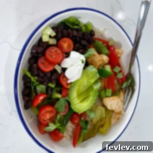 Delicious Sheet Pan Burrito Bowls with chicken and fajita vegetables