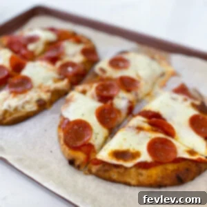Delicious and crispy naan bread pizzas with pepperoni and melted mozzarella cheese, ready to eat.
