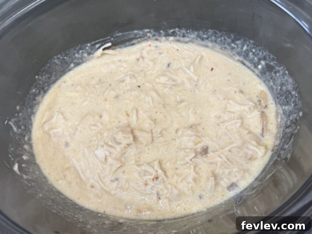 Cozy Slow Cooker Creamy Chicken Pasta 7 Shredding tender creamy chicken from the slow cooker