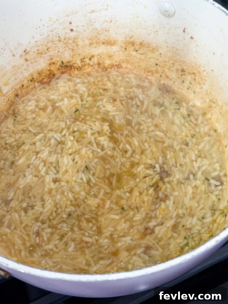 Hearty Italian Sausage and Rice 4 Cooking creamy chicken rice in a skillet for Italian sausage dinner