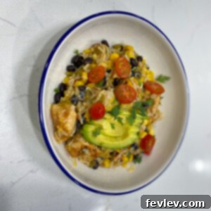 Delicious Loaded Rice Burrito Bowl with chicken, beans, corn, and cheese