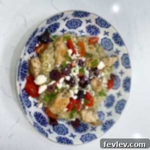 Delicious Greek Chicken and Rice Bowls with tender chicken, rice, tomatoes, olives, and feta cheese