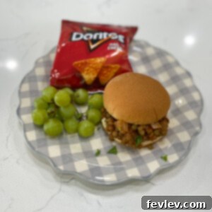 Delicious Lentil Sloppy Joes piled high on toasted hamburger buns, garnished with fresh parsley.