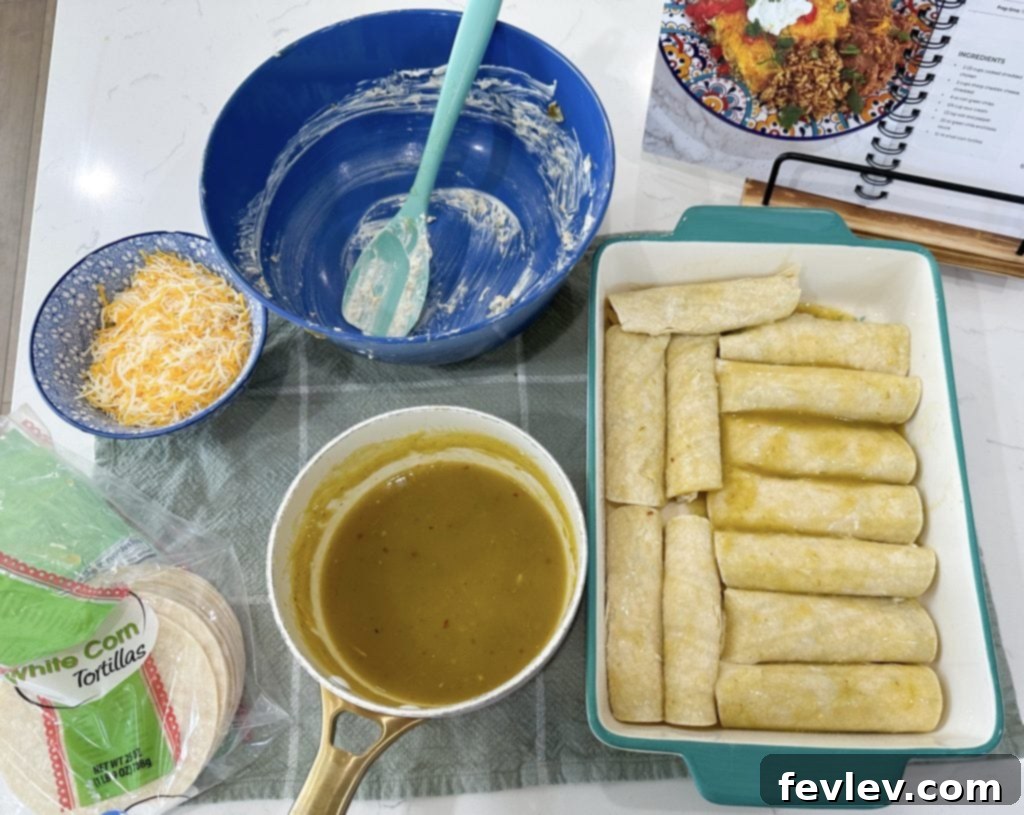 Rolling chicken enchiladas with green chile sauce