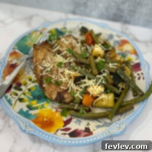 A vibrant sheet pan meal with Italian chicken, cherry tomatoes, zucchini, and green beans.