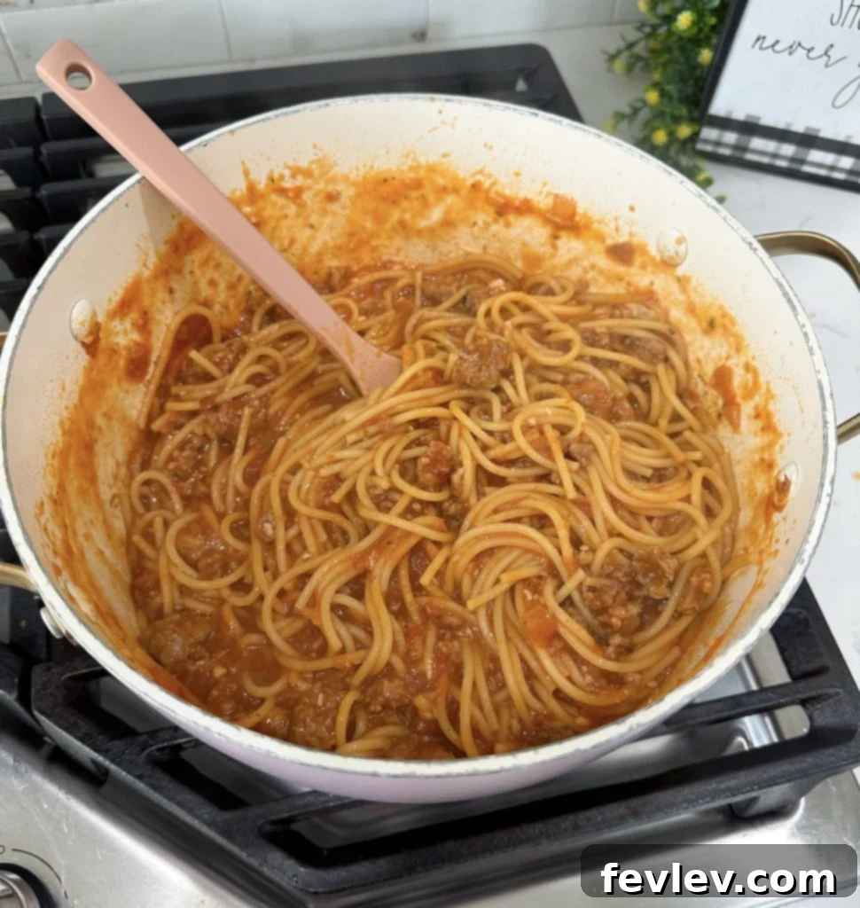 Adding spaghetti to the pot