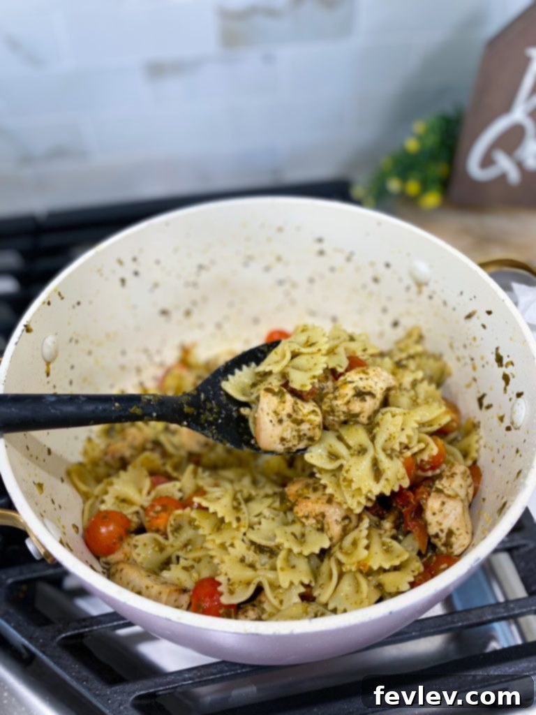 Delicious One-Pot Sun-Dried Tomato Chicken Pasta served fresh from a cast-iron skillet, garnished with basil leaves, ready to be enjoyed.