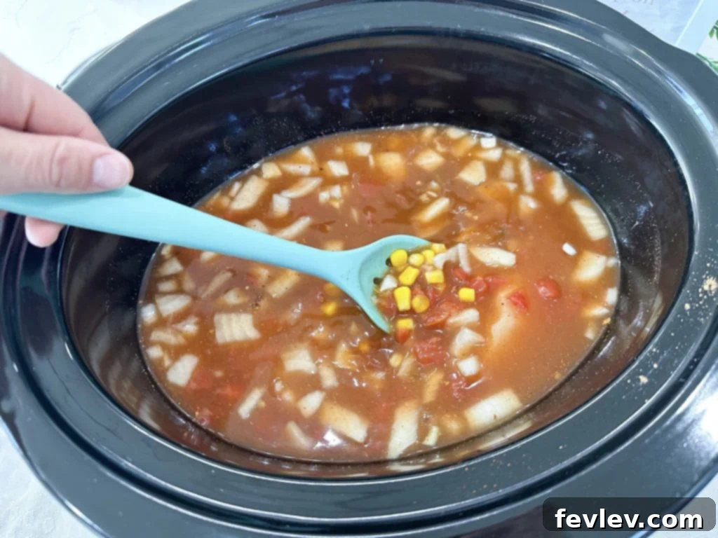 Hearty Slow Cooker Chicken Tortilla Soup 3 Adding ingredients to the slow cooker for chicken tortilla soup
