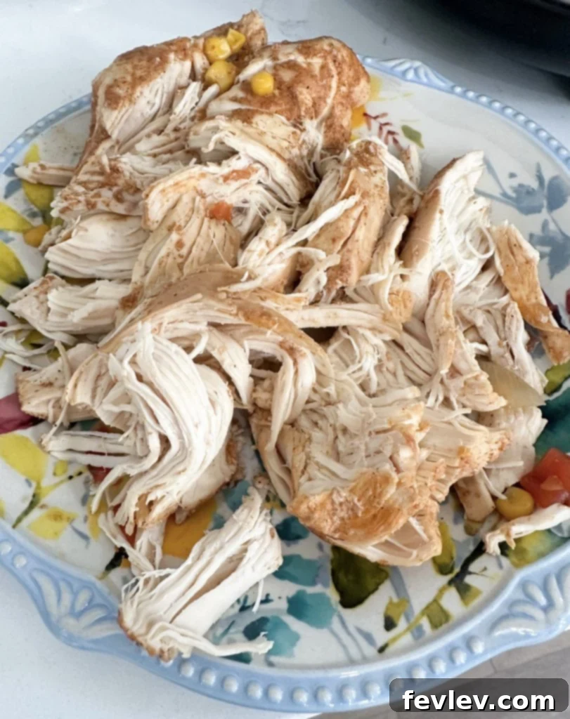 Hearty Slow Cooker Chicken Tortilla Soup 4 Shredded chicken in slow cooker for tortilla soup